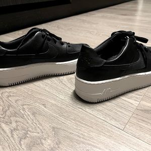 Nike AF1. Never worn. Perfect condition! Black leather w/ white platform sole.